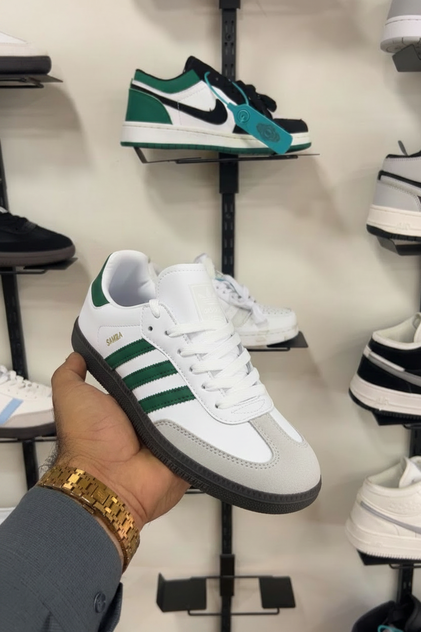 Adidas Samba Green Stripe with Gold SAMBA text held in hand at shoe store